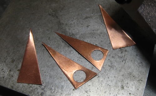 Step 4 - holes (a little smaller than diameter of domed discs)  punched in copper triangles.